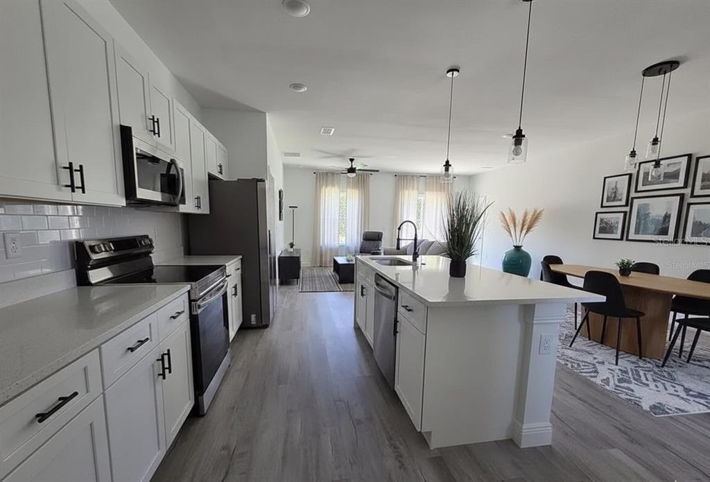 4863 Southwest 159th Lane Ocala, FL 34473 - Photo 3 of 16 a large kitchen with stainless steel appliances lots of counter space and a sink