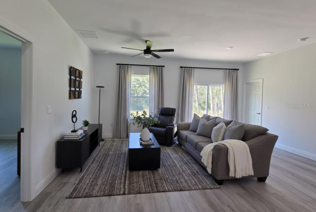 4863 Southwest 159th Lane Ocala, FL 34473 - Photo 4 of 16 a living room with furniture and wooden floor