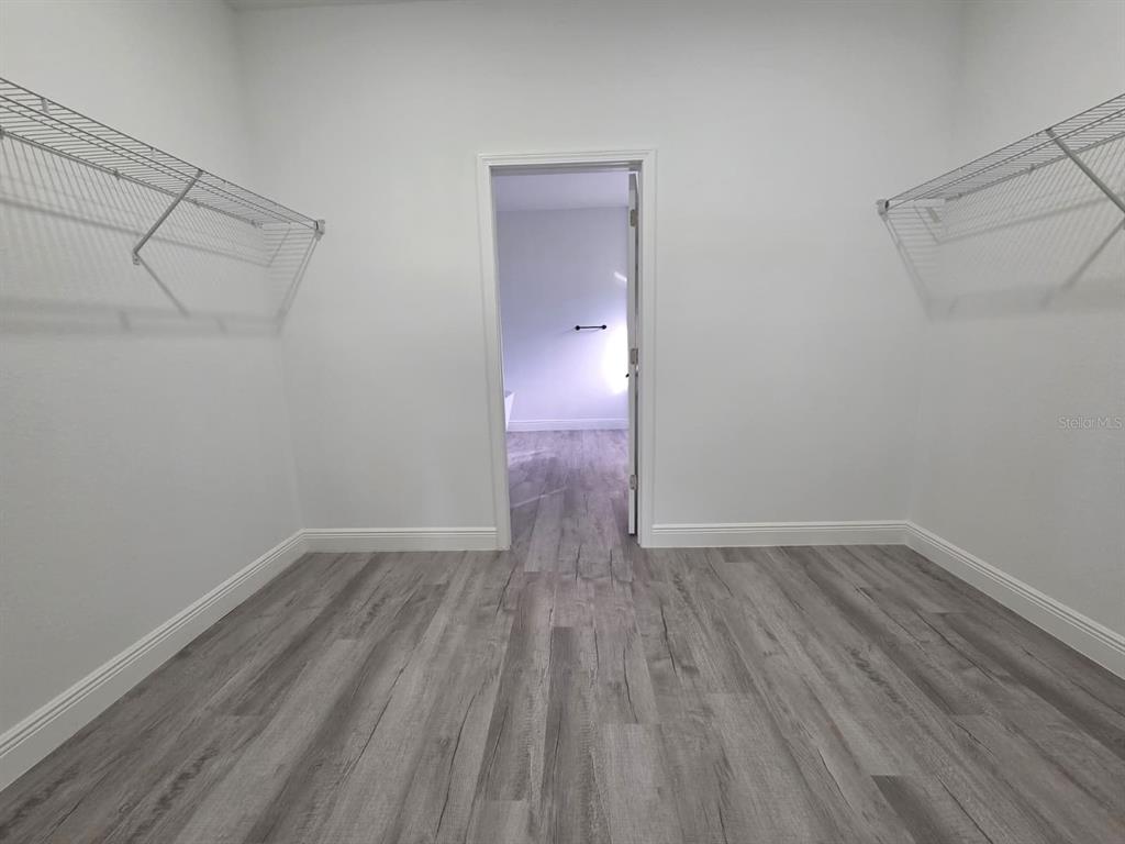 4863 Southwest 159th Lane Ocala, FL 34473 - Photo 8 of 16 a view of an empty room with wooden floor