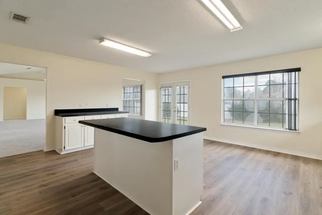 a kitchen with granite countertop a sink and a stove top oven