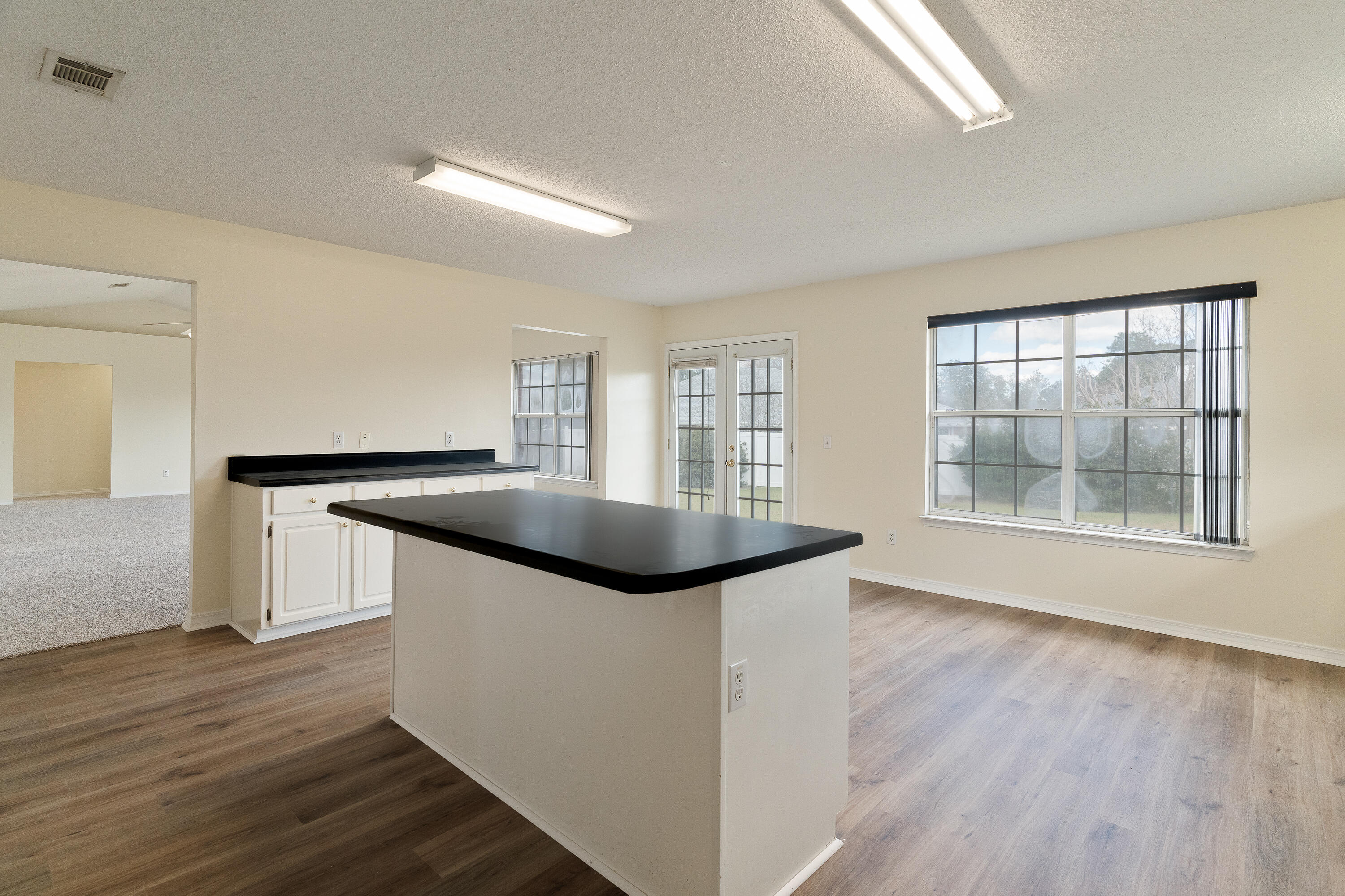 2837 Tamiami Trail Crestview, FL 32539 - Photo 12 of 33 a kitchen with granite countertop a sink and a stove top oven