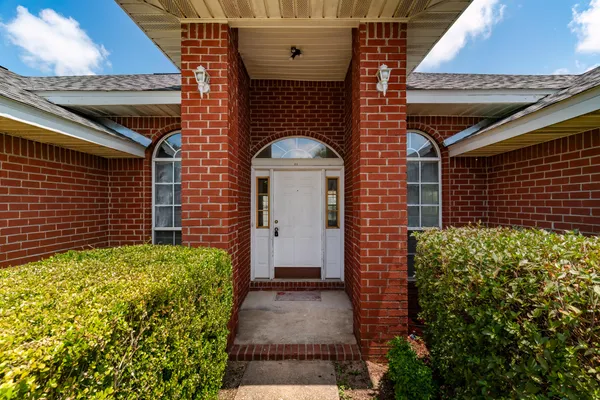 a view of a brick house with a large windows