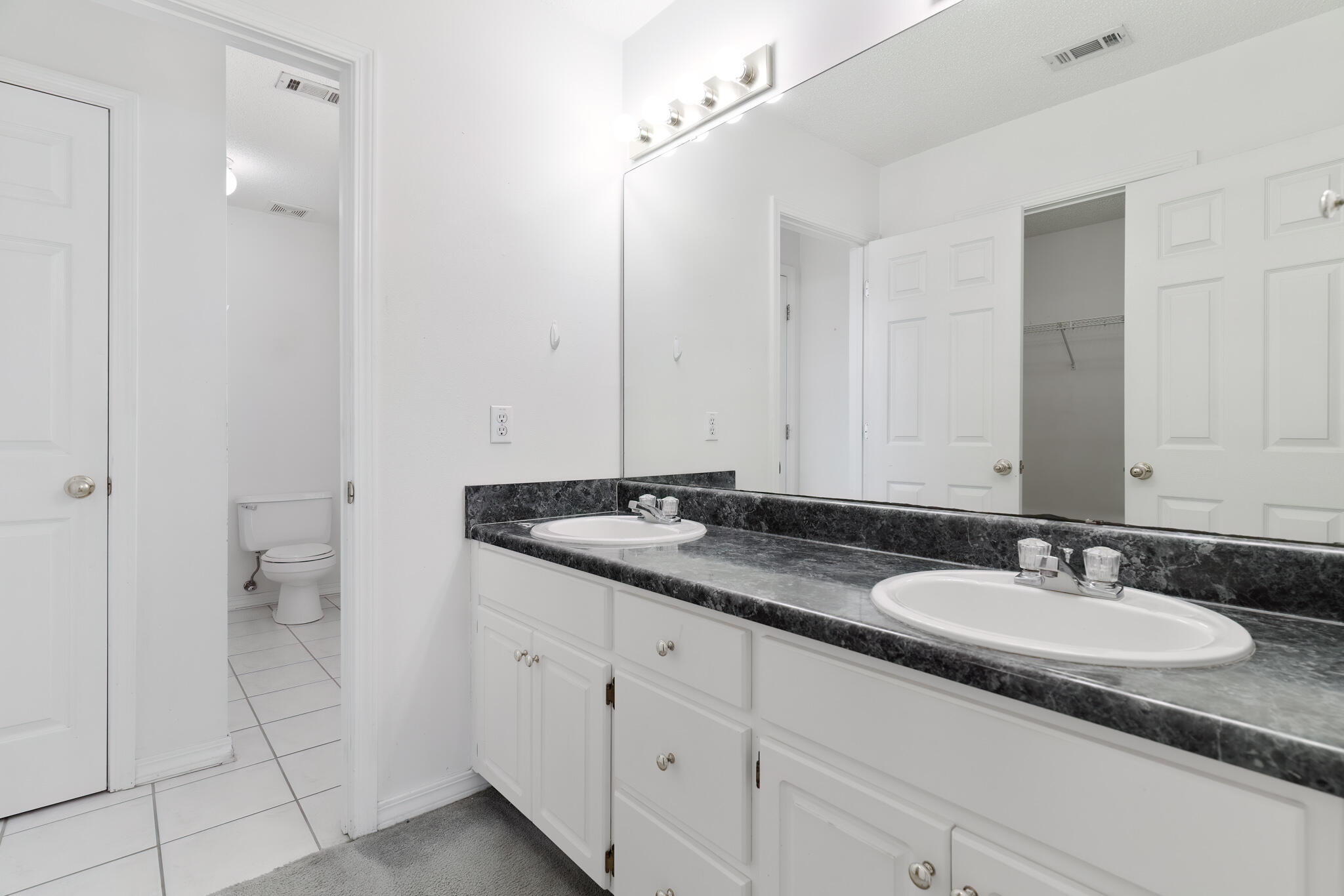 2837 Tamiami Trail Crestview, FL 32539 - Photo 21 of 33 a bathroom with a granite countertop sink and a mirror