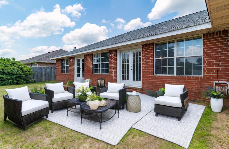 2837 Tamiami Trail Crestview, FL 32539 - Photo 3 of 33 a view of a patio with couches table and chairs and potted plants