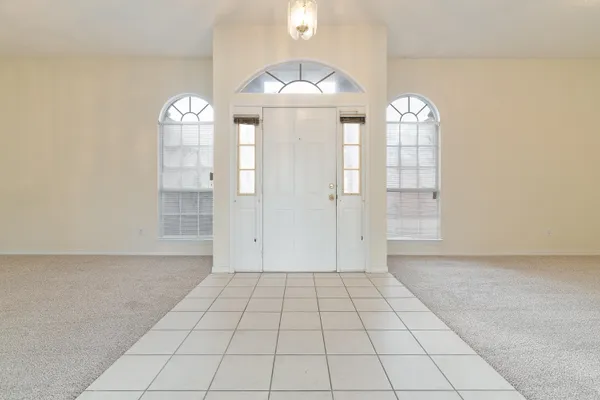 a view of a livingroom with wooden floor and a window