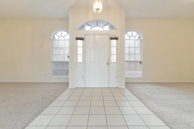 a view of a livingroom with wooden floor and a window