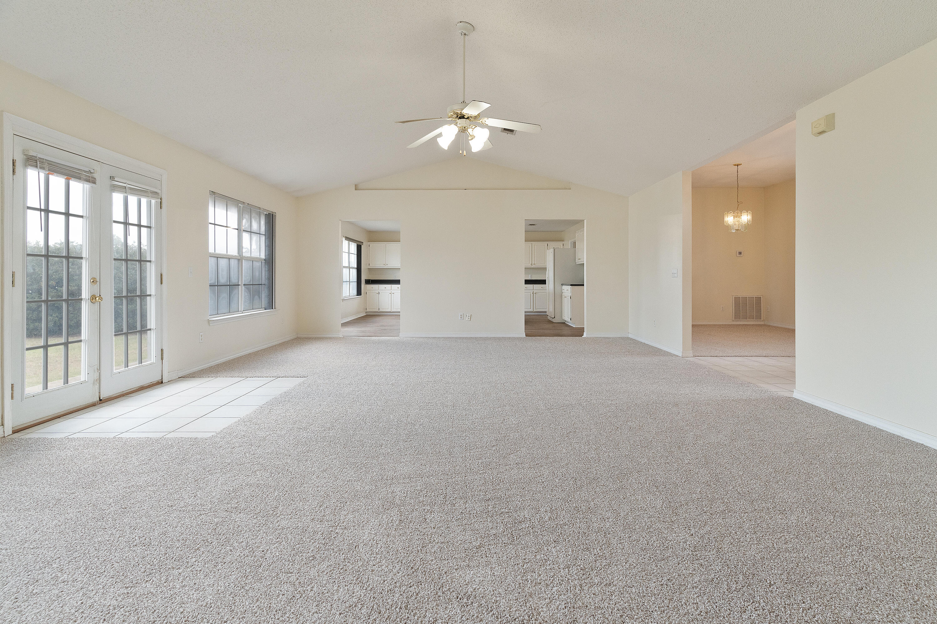 2837 Tamiami Trail Crestview, FL 32539 - Photo 8 of 33 a view of a big room with windows and chandelier fan