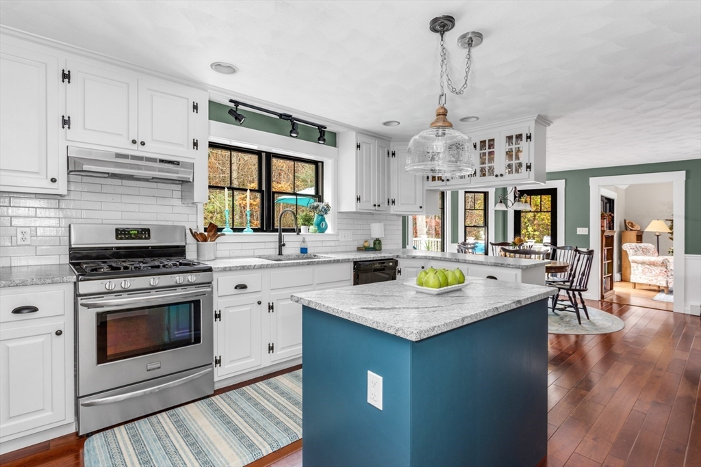 8 Bubbling Brook Road Franklin, MA 02038 - Photo 12 of 46 a kitchen with stainless steel appliances granite countertop a stove a sink dishwasher and white cabinets with wooden floor