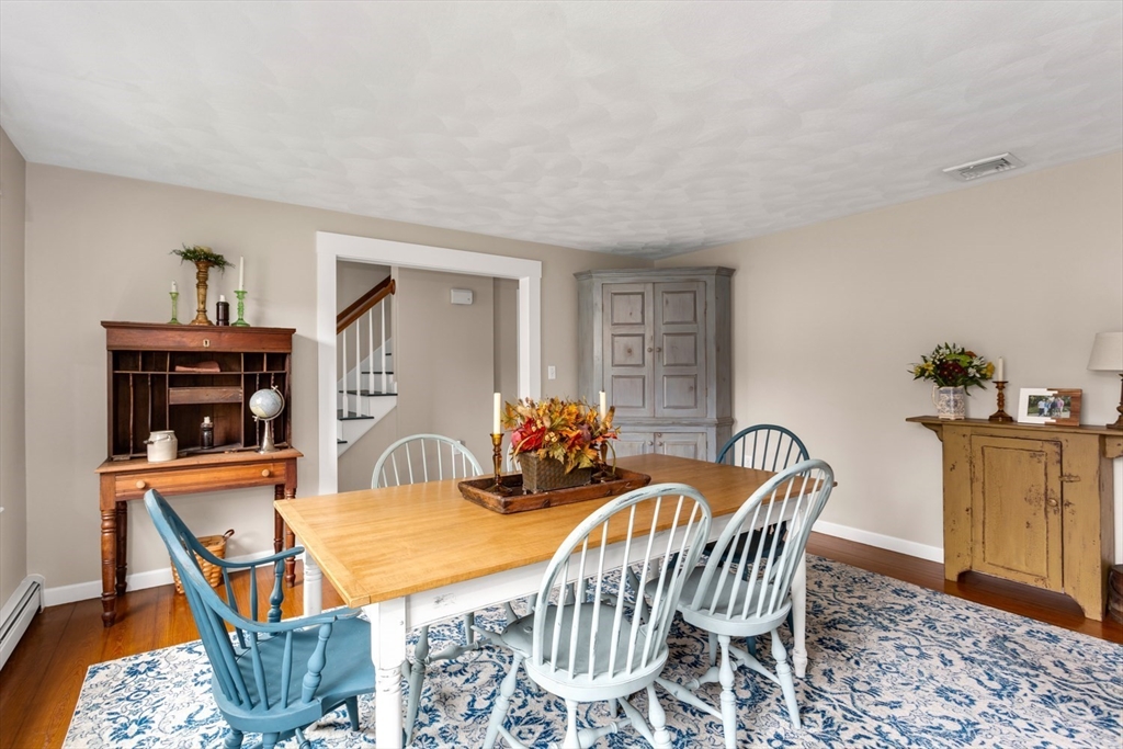 8 Bubbling Brook Road Franklin, MA 02038 - Photo 17 of 46 a view of a dining room with furniture and wooden floor