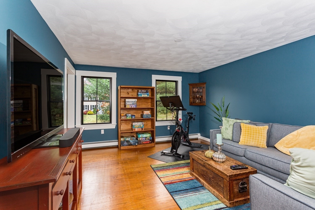 8 Bubbling Brook Road Franklin, MA 02038 - Photo 18 of 46 a living room with furniture a rug and a flat screen tv