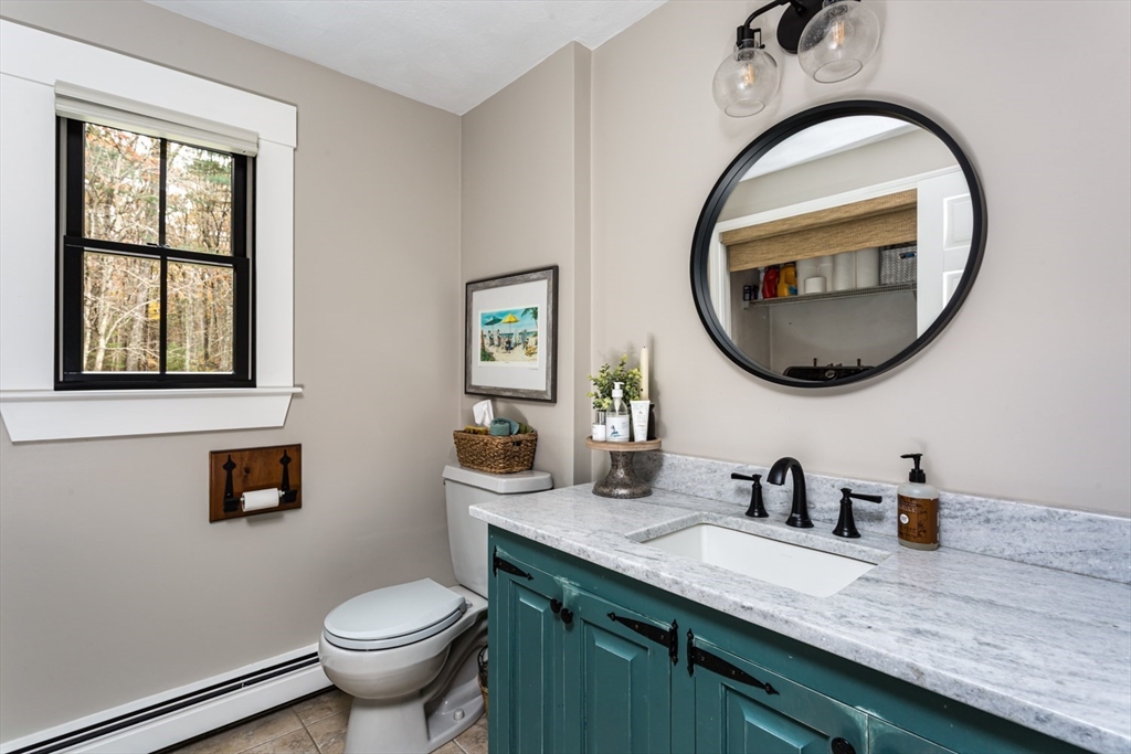 8 Bubbling Brook Road Franklin, MA 02038 - Photo 20 of 46 a bathroom with a toilet a sink and a mirror