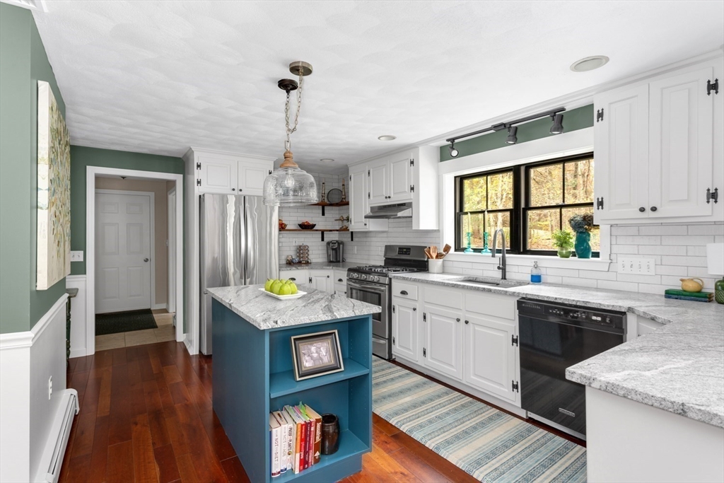 8 Bubbling Brook Road Franklin, MA 02038 - Photo 2 of 46 a kitchen with granite countertop kitchen island stainless steel appliances a sink stove and refrigerator