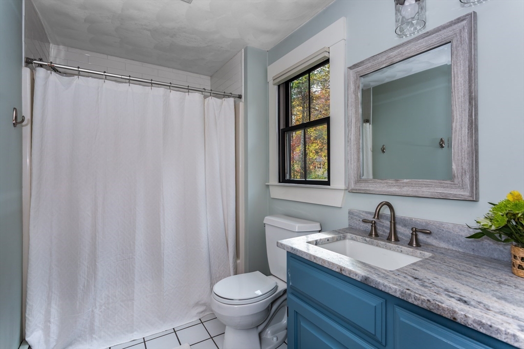8 Bubbling Brook Road Franklin, MA 02038 - Photo 26 of 46 a bathroom with a granite countertop sink and a mirror