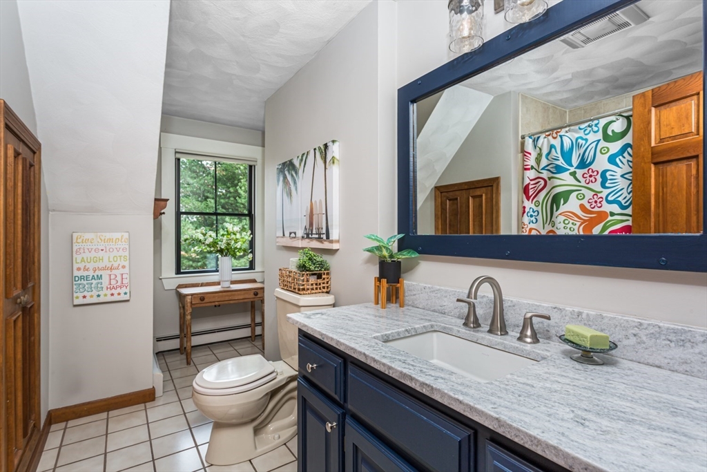 8 Bubbling Brook Road Franklin, MA 02038 - Photo 29 of 46 a bathroom with a granite countertop sink and a large mirror