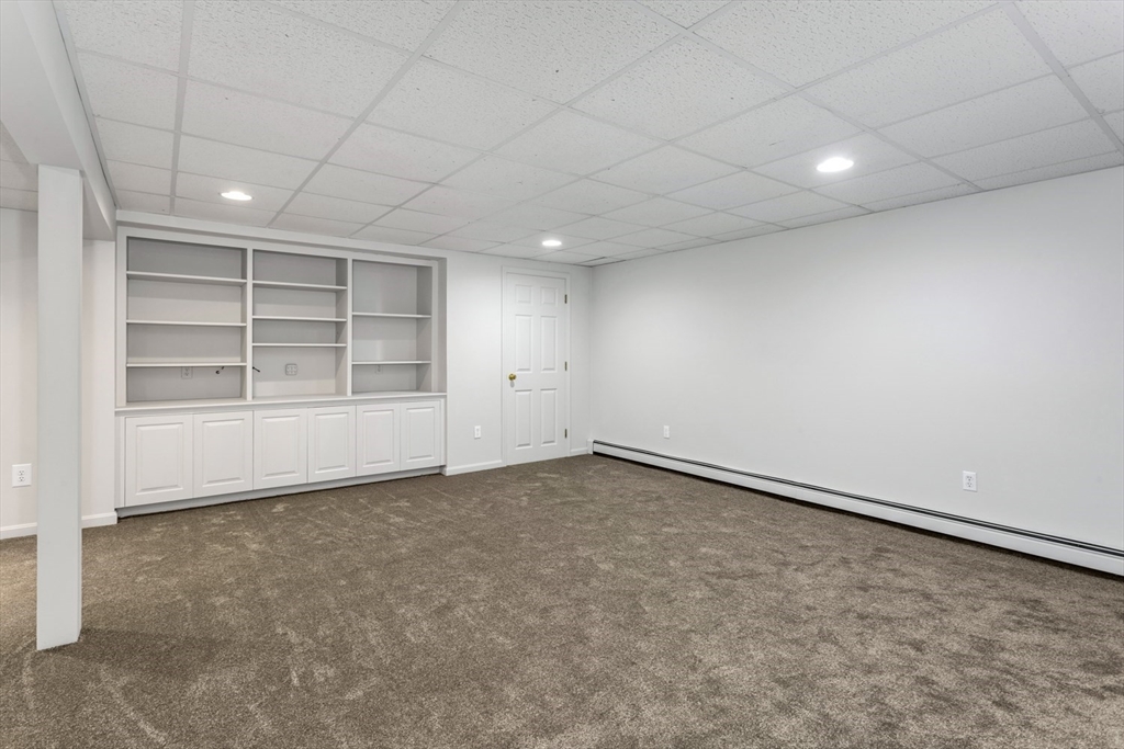 8 Bubbling Brook Road Franklin, MA 02038 - Photo 32 of 46 an empty room with a empty space and windows