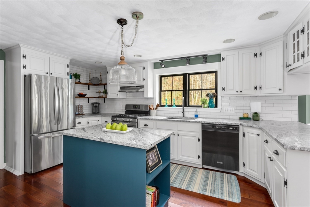8 Bubbling Brook Road Franklin, MA 02038 - Photo 7 of 46 a kitchen with refrigerator cabinets and wooden floor