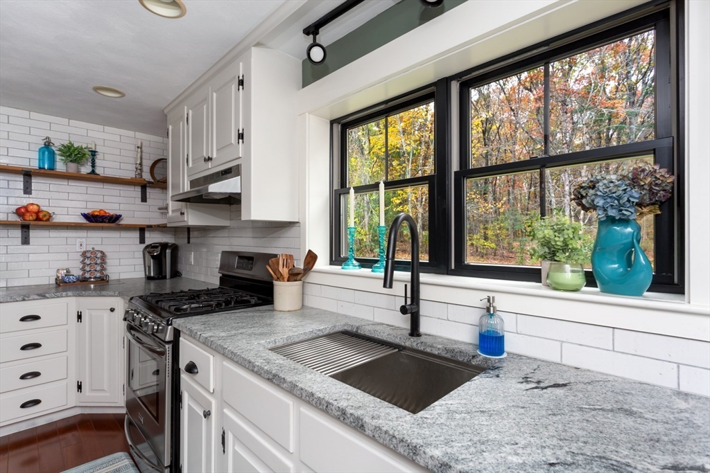 8 Bubbling Brook Road Franklin, MA 02038 - Photo 10 of 46 a kitchen with sink a stove and cabinets