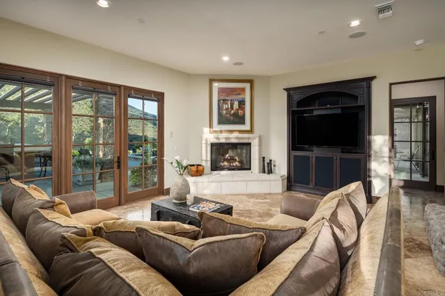 a living room with furniture a fireplace and a flat screen tv