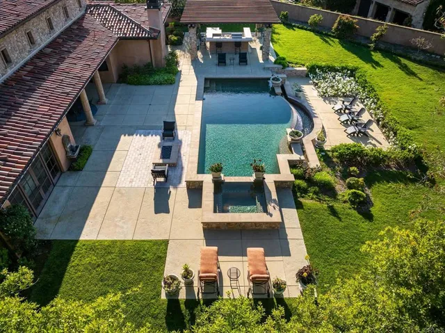 an aerial view of a house with a yard basket ball court and outdoor seating