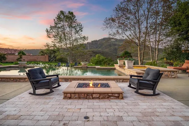 a view of a patio with table and chairs and a fire pit