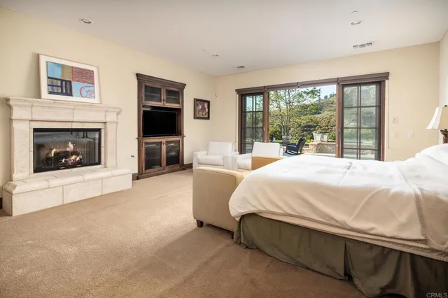 a spacious bedroom with a bed and a fireplace