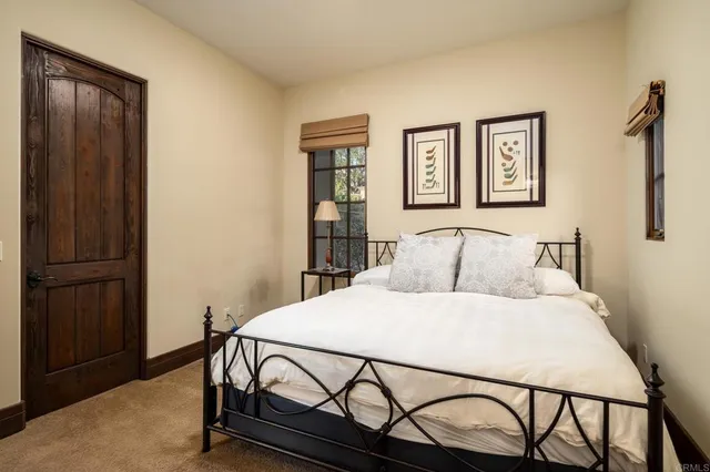 a bedroom with a bed and table with closet