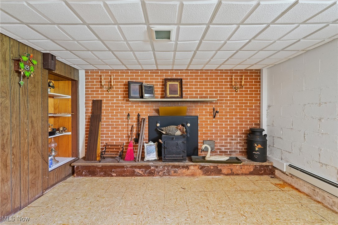3612 Ridge Road Cortland, OH 44410 - Photo 24 of 36 Recreation room with a wood stove, tile patterned floors.