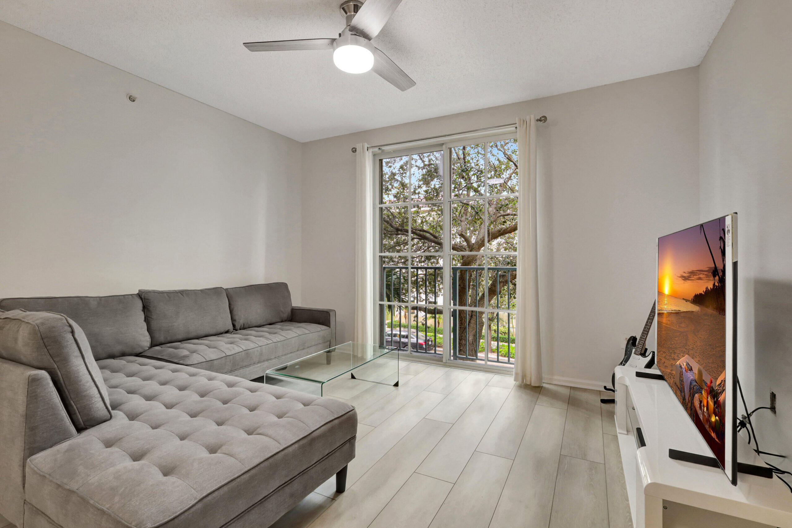 630 South Sapodilla Avenue, Unit 223 West Palm Beach, FL 33401 - Photo 1 of 43 a living room with furniture and a flat screen tv