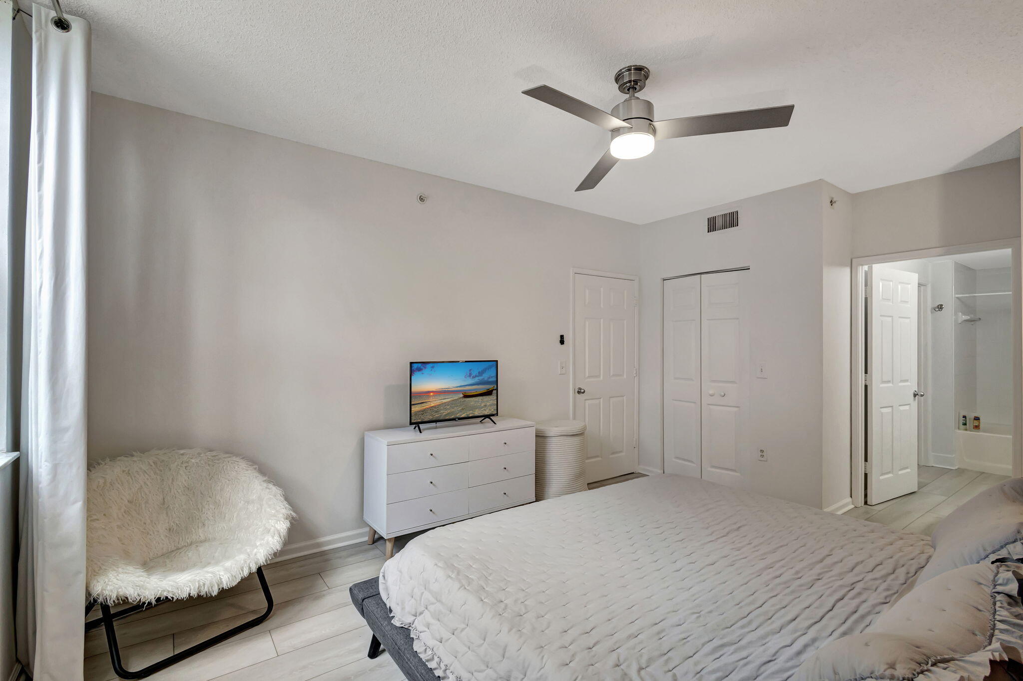 630 South Sapodilla Avenue, Unit 223 West Palm Beach, FL 33401 - Photo 21 of 43 a bedroom with a bed and a chair