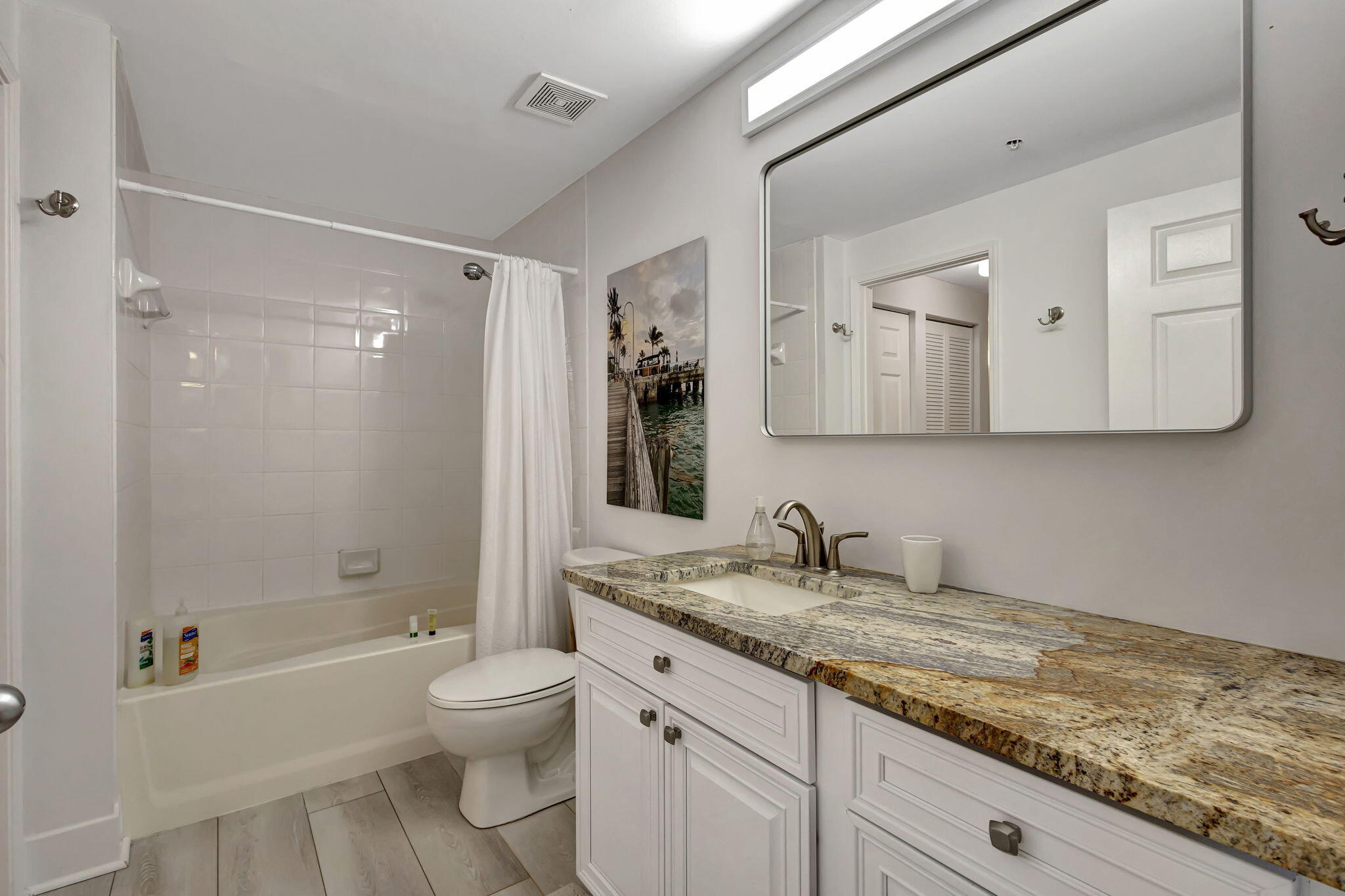 630 South Sapodilla Avenue, Unit 223 West Palm Beach, FL 33401 - Photo 22 of 43 a bathroom with a granite countertop sink toilet and shower
