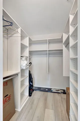 a view of walk in closet with empty racks