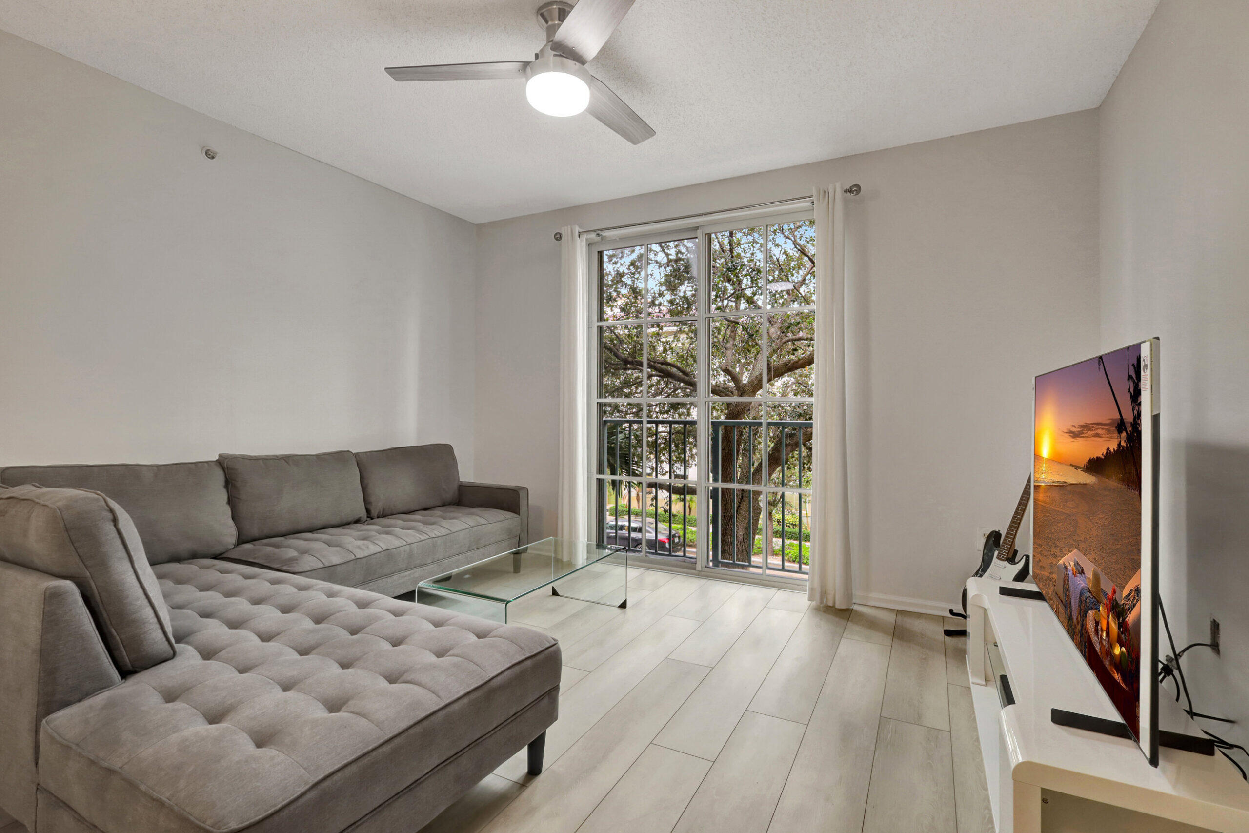 630 South Sapodilla Avenue, Unit 223 West Palm Beach, FL 33401 - Photo 4 of 43 a living room with furniture and a flat screen tv