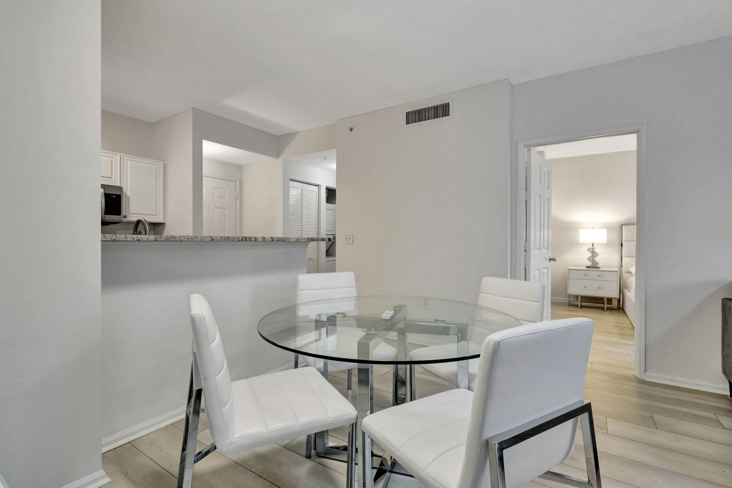 630 South Sapodilla Avenue, Unit 223 West Palm Beach, FL 33401 - Photo 7 of 43 a view of a dining room with furniture and wooden floor