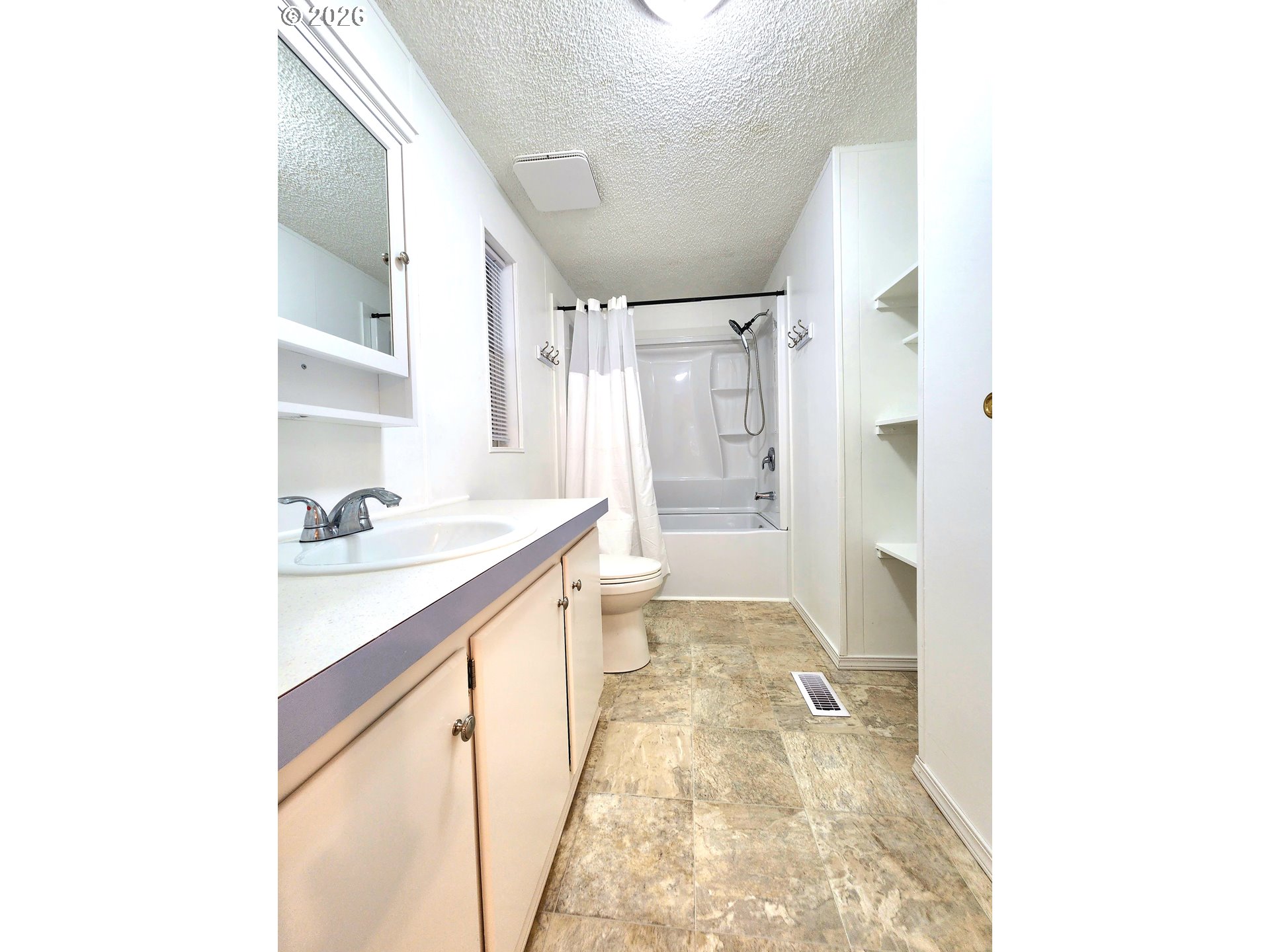 874 South Main Street Canyonville, OR 97417 - Photo 13 of 30 a bathroom with a granite countertop sink a mirror and a shower