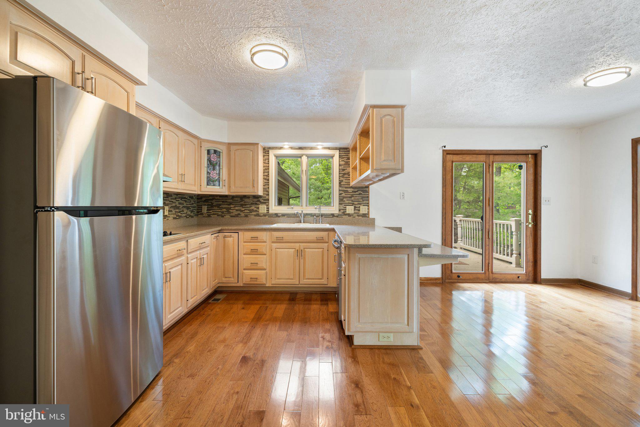 155 Connie Road Basye, VA 22810 - Photo 20 of 76 a kitchen with a refrigerator a sink and white cabinets