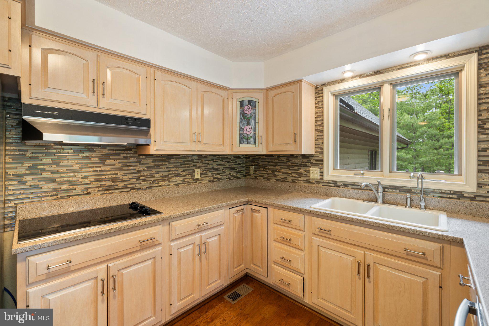 155 Connie Road Basye, VA 22810 - Photo 21 of 76 a kitchen with sink cabinets and window