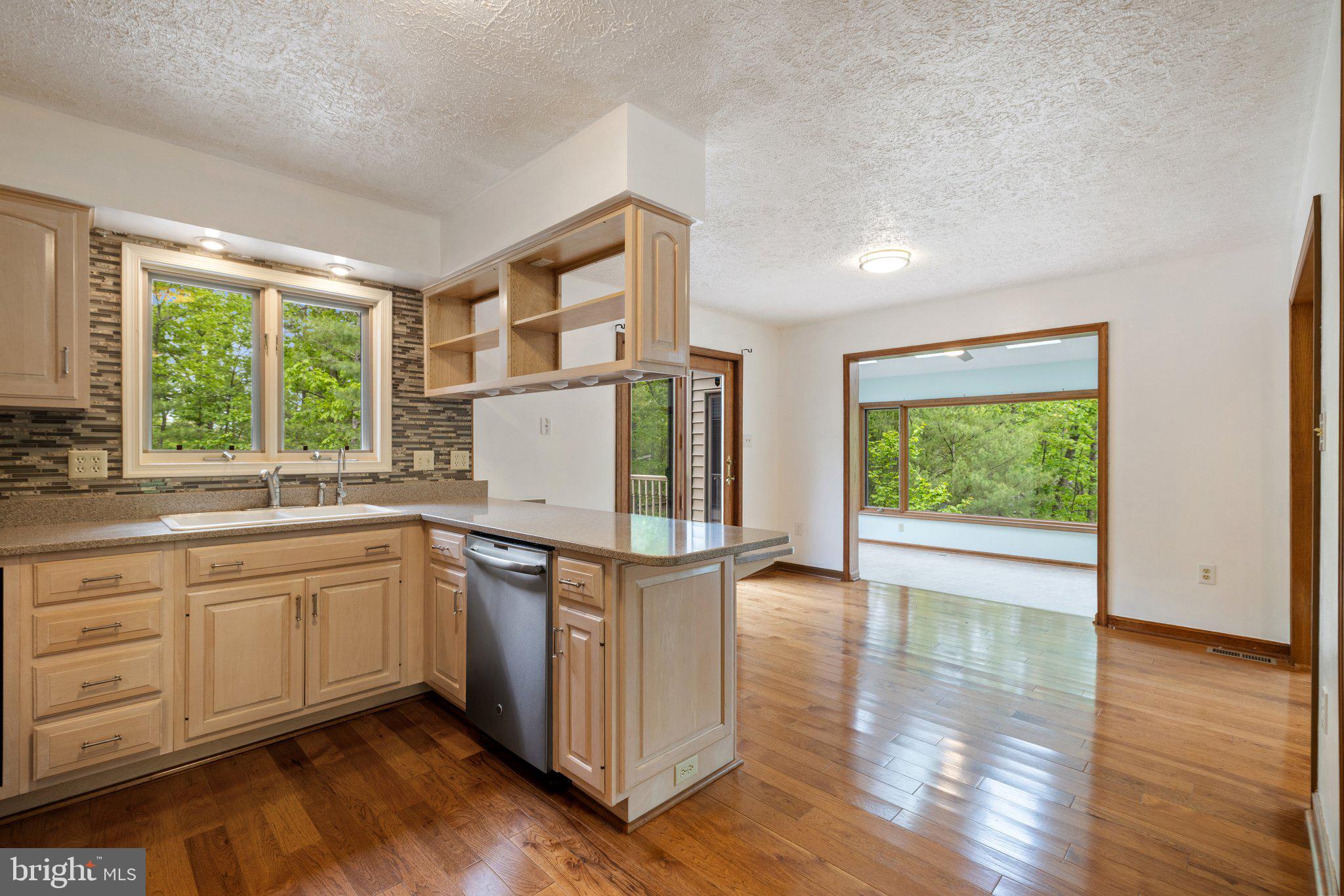 155 Connie Road Basye, VA 22810 - Photo 22 of 76 a kitchen with stainless steel appliances granite countertop a stove and a large window