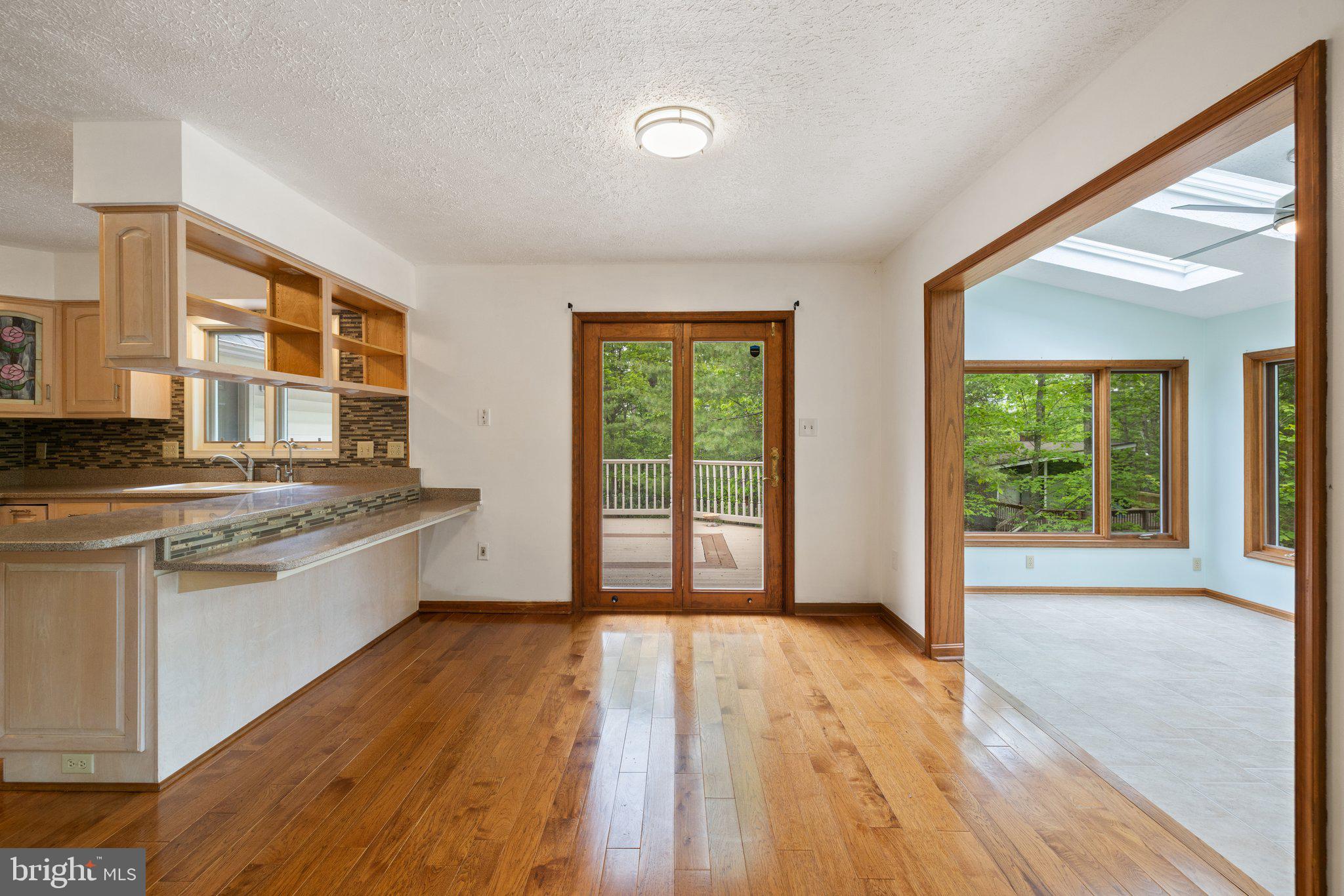 155 Connie Road Basye, VA 22810 - Photo 26 of 76 a large kitchen with granite countertop a large window a sink and stainless steel appliances