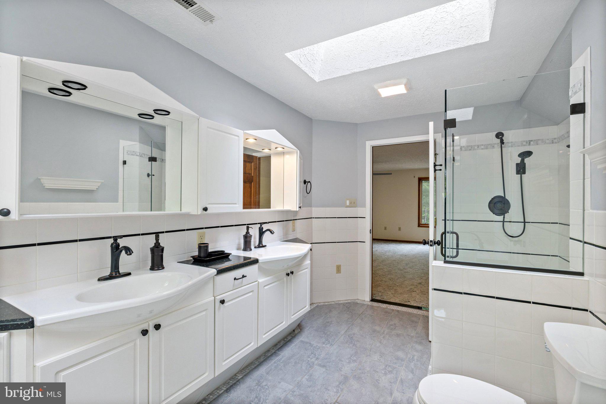 155 Connie Road Basye, VA 22810 - Photo 46 of 76 a bathroom with a double vanity sink mirror and shower
