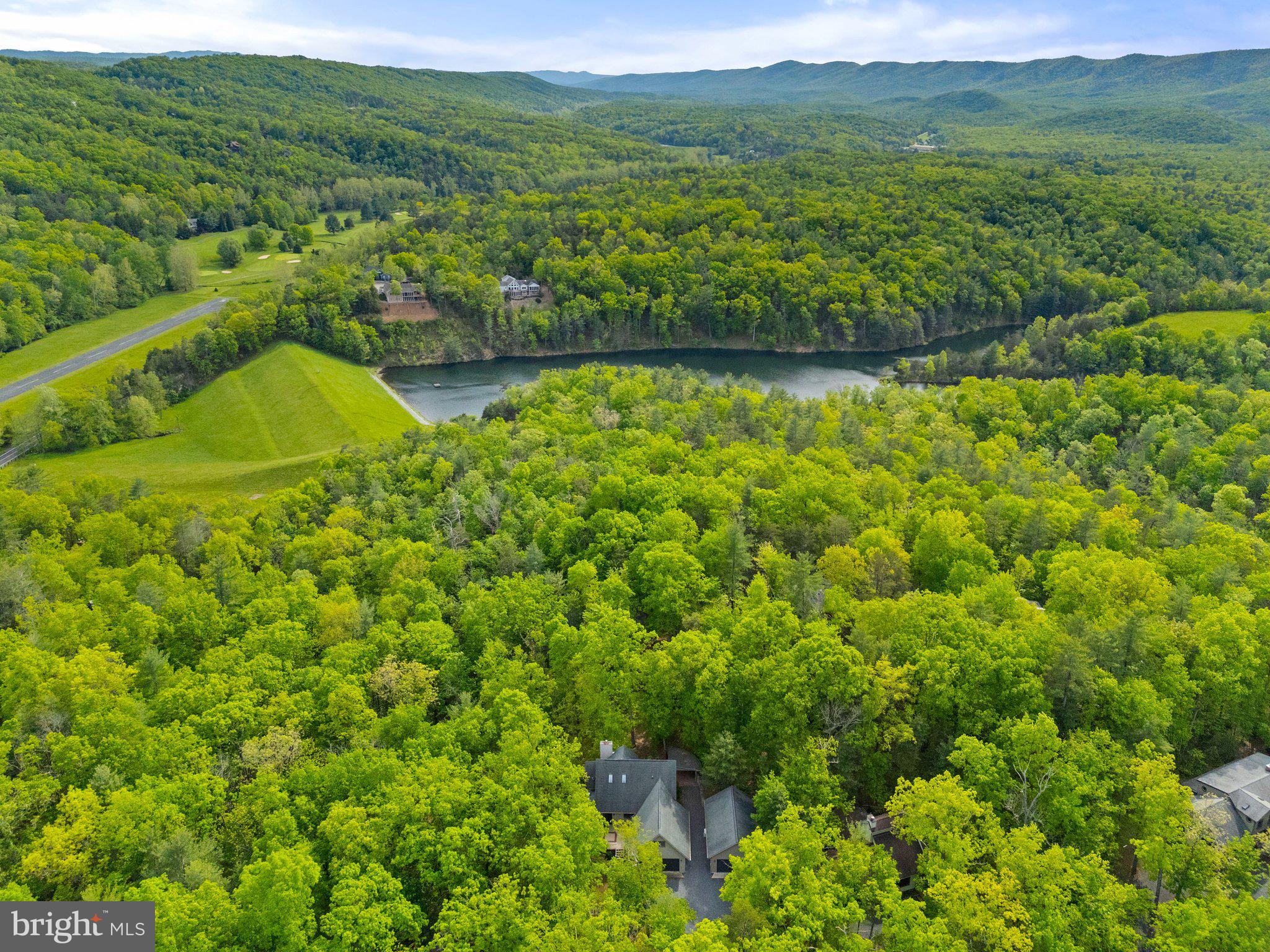 155 Connie Road Basye, VA 22810 - Photo 74 of 76 a view of a lush green field with a houses in the background