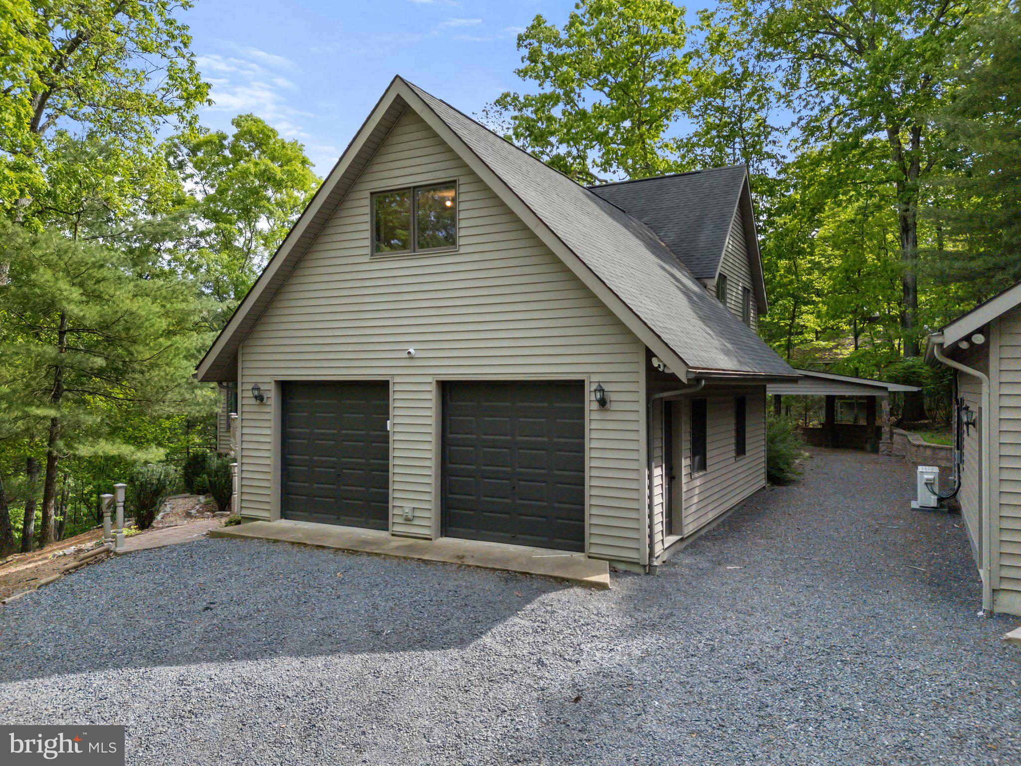 155 Connie Road Basye, VA 22810 - Photo 8 of 76 a view of a house with a yard and garage