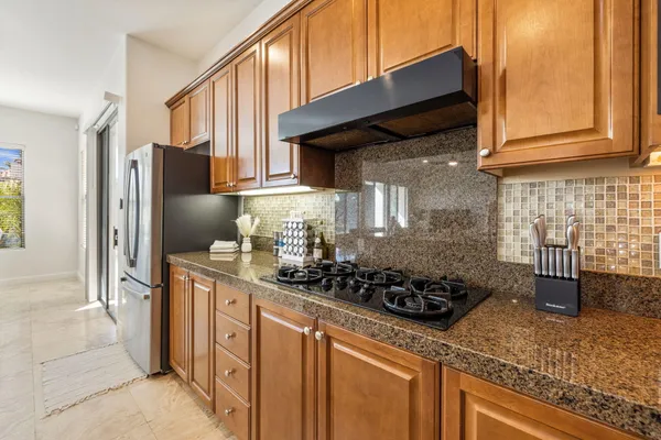 a view of a swimming pool with a garden and palm trees