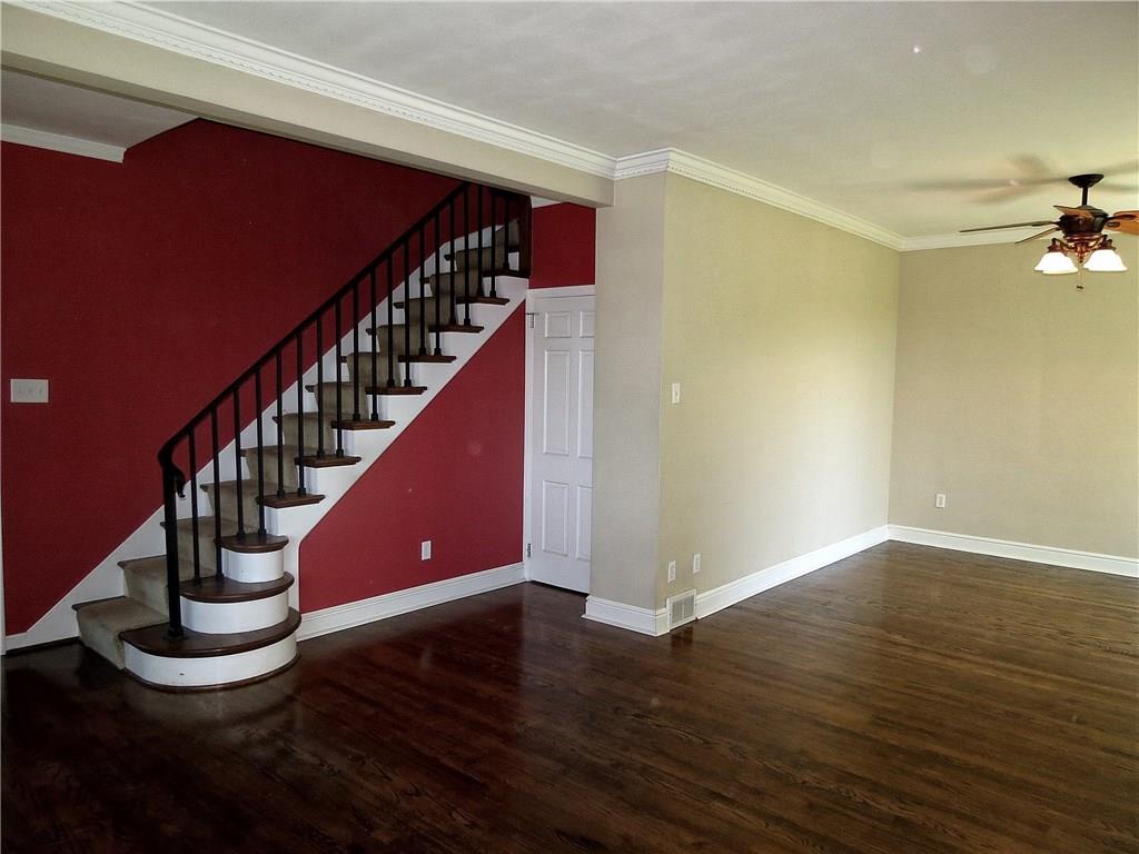 Upon entrance guests are greeted by an inviting 14X6 foyer with a sweeping wood staircase and transomed entryway.