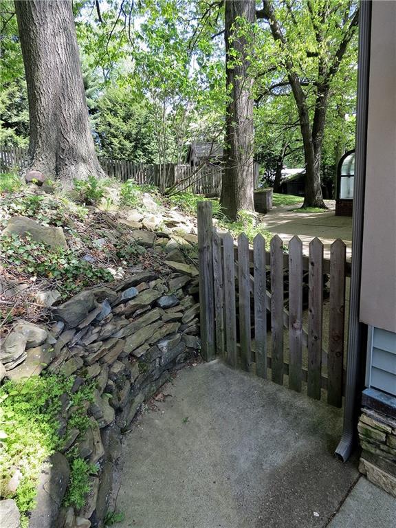 670 Meadow Lane Rochester, PA 15074 - Photo 16 of 21 A charming gate leads to the rear patio and entrance to a picturesque rear yard that is made for leisure.