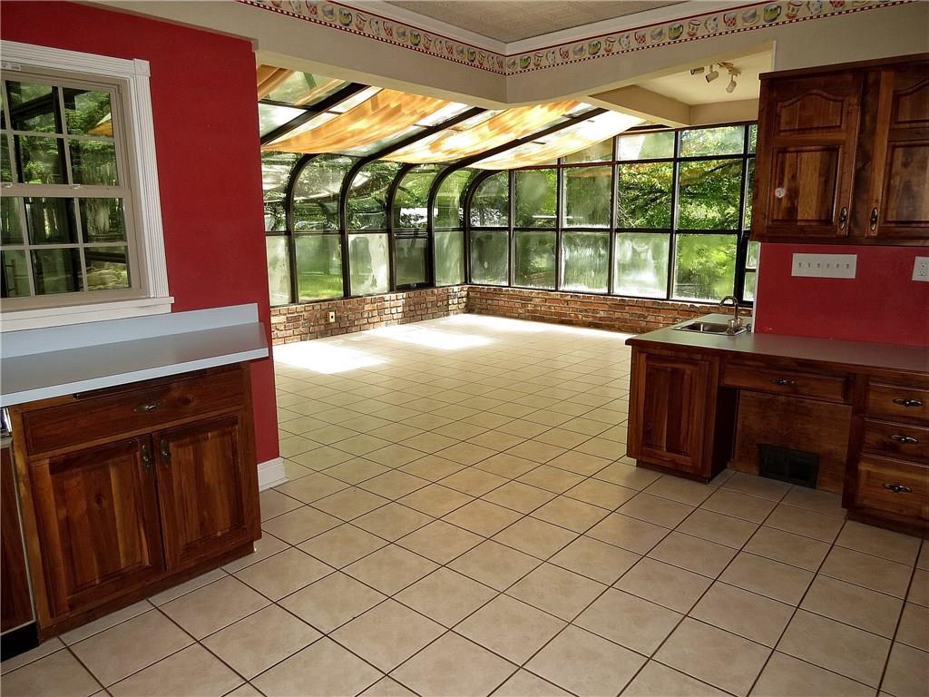 The already large 15X15 kitchen has been greatly expanded with a sunlit infusing solarium allowing sweeping views of the rear yard.