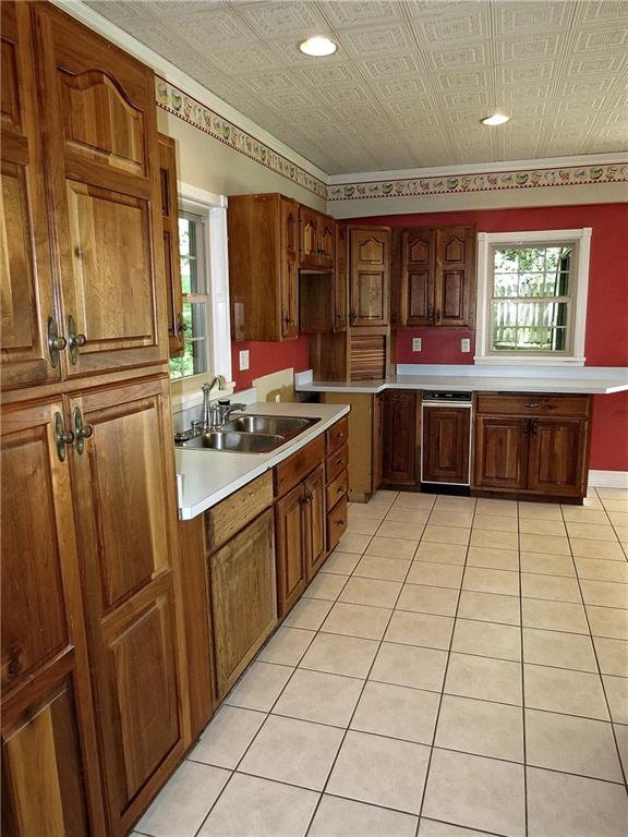 Wood cabinets, 2 pantries, ceramic tiled floors, recessed lighting, crown molding, high clearance brushed nickel faucet & an appliance garage are a few fine features in the kitchen. 