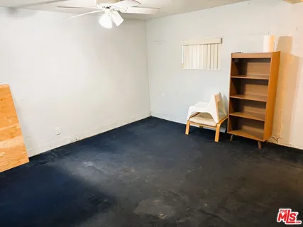 a view of room with window and cabinet