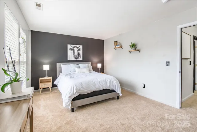 a spacious bedroom with a bed and a couch