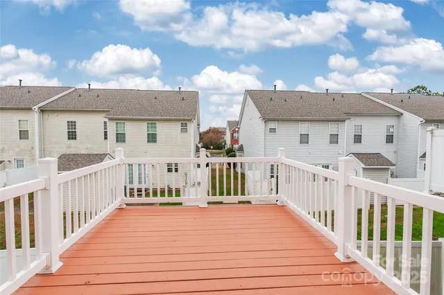 a view of a house with wooden deck