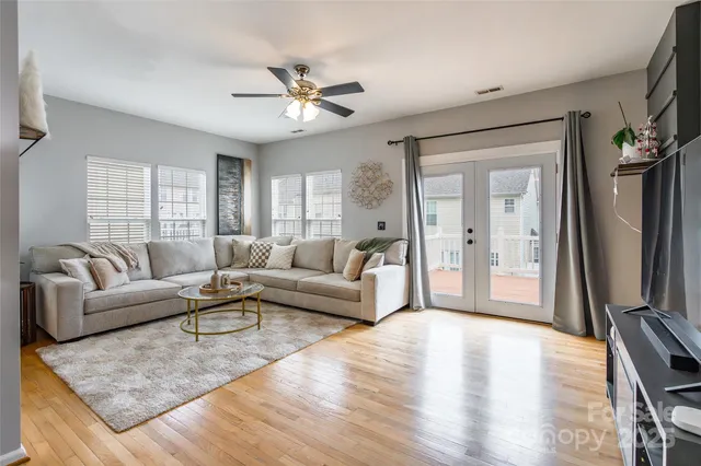 a living room with furniture and a large mirror